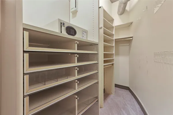 a view of walk in closet with empty racks