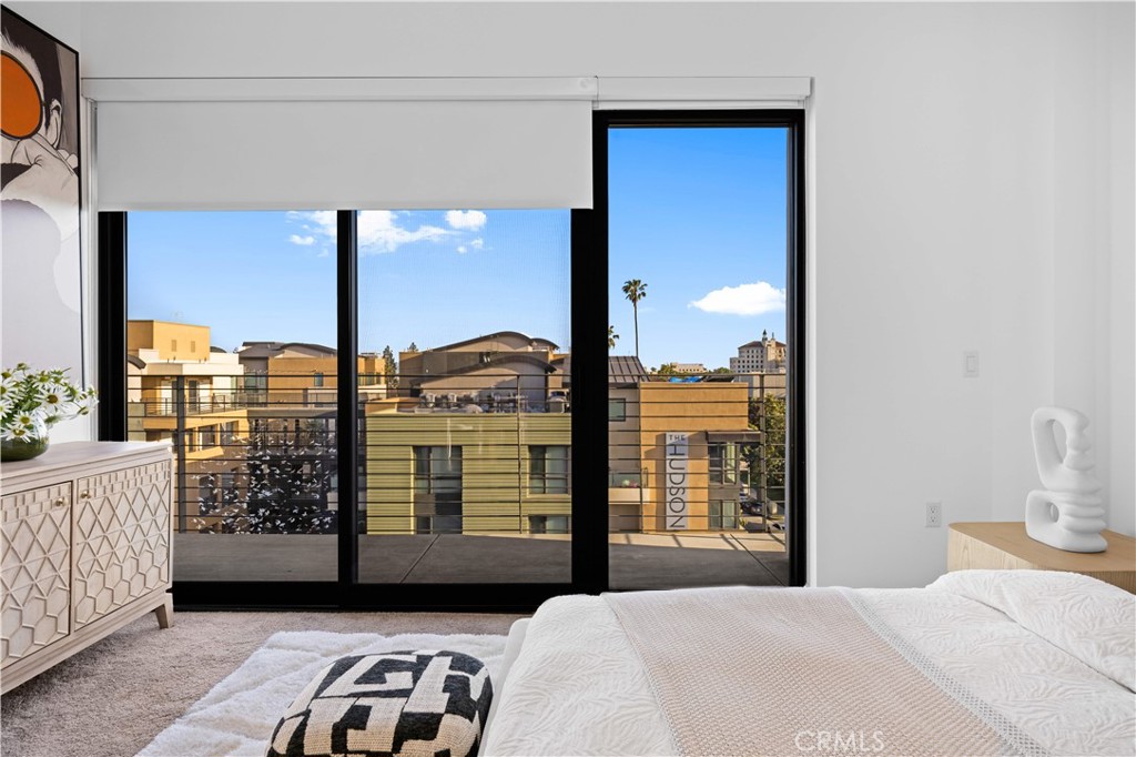 218 North El Molino Avenue, Unit 502 Pasadena, CA 91101 - Photo 11 of 35 a bedroom with a large window and walk in closet