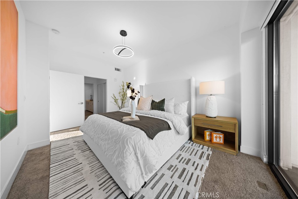 218 North El Molino Avenue, Unit 502 Pasadena, CA 91101 - Photo 13 of 35 a bedroom with a bed and wooden floor