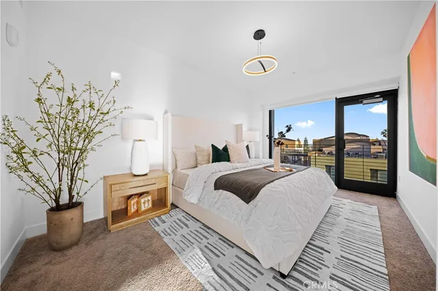 a spacious bedroom with a large bed and large windows