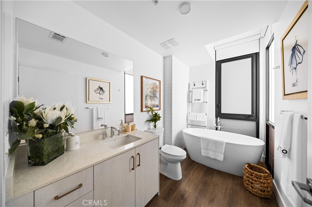 218 North El Molino Avenue, Unit 502 Pasadena, CA 91101 - Photo 16 of 35 a bathroom with a tub sink mirror and a bathtub