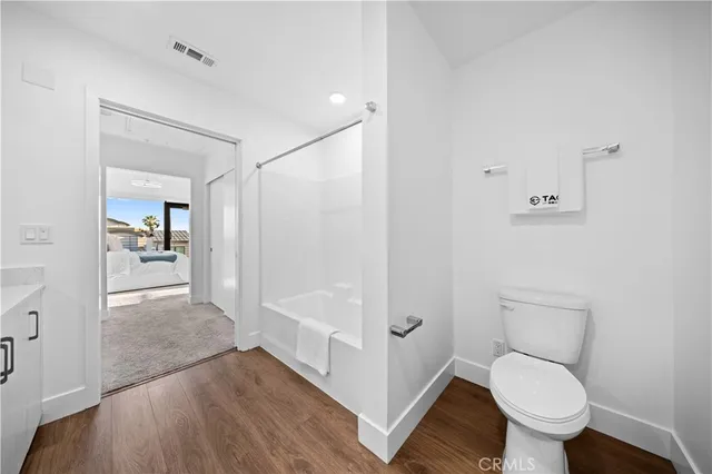 a bathroom with a toilet and a shower