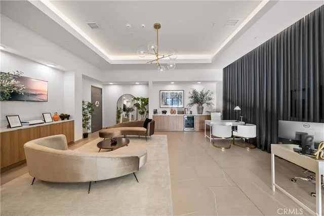 a living room with furniture and a chandelier