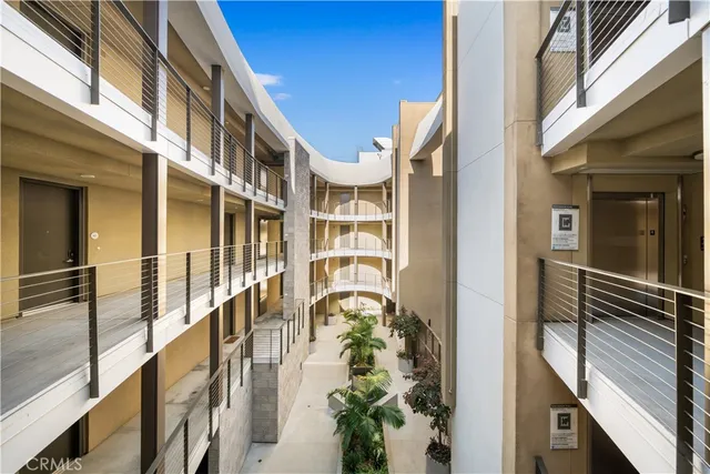 a lobby with furniture and a potted plant