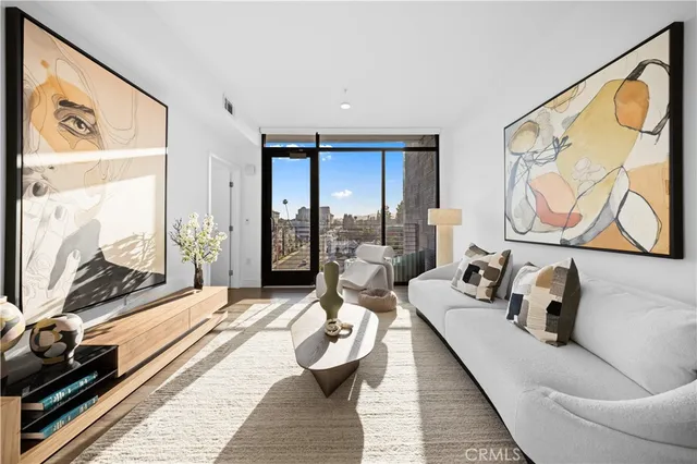 a living room with furniture and a floor to ceiling window