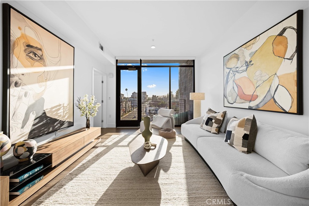 218 North El Molino Avenue, Unit 502 Pasadena, CA 91101 - Photo 3 of 35 a living room with furniture and a floor to ceiling window