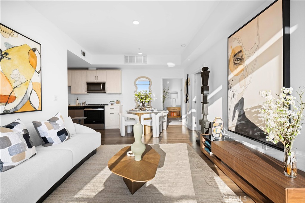 218 North El Molino Avenue, Unit 502 Pasadena, CA 91101 - Photo 7 of 35 a living room with furniture fireplace and a flat screen tv