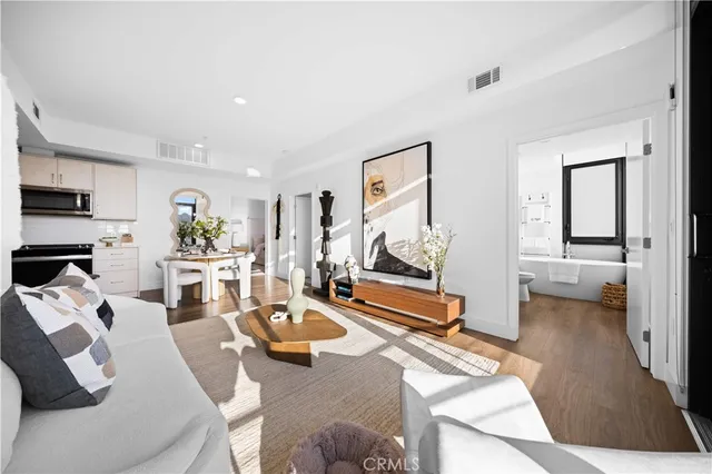 a living room with furniture a flat screen tv and a large window