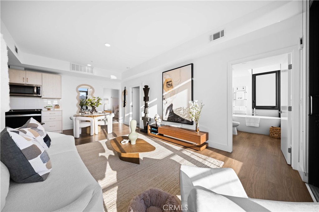218 North El Molino Avenue, Unit 502 Pasadena, CA 91101 - Photo 8 of 35 a living room with furniture a flat screen tv and a large window