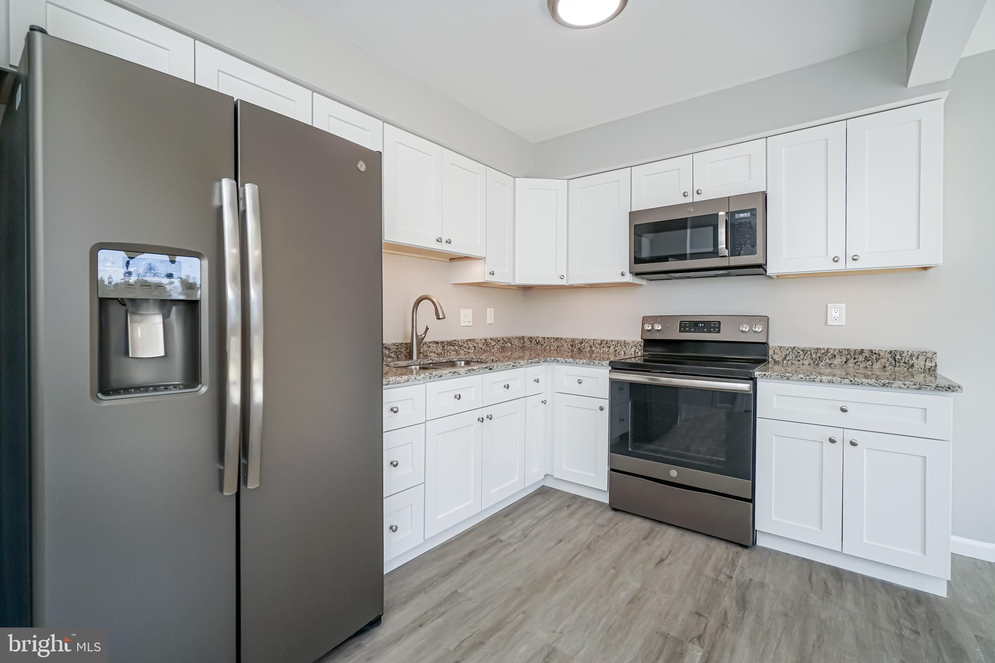 18 Hatteras Court Elkton, MD 21921 - Photo 5 of 21 a kitchen with cabinets stainless steel appliances and wooden floor