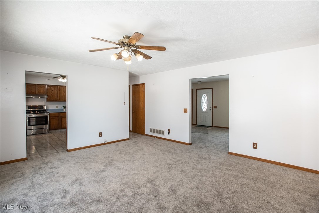 2624 Lester Road Medina, OH 44256 - Photo 18 of 50 Family Room or Dining Room with newer carpet and slider to composite deck, rear yard and outbuilding