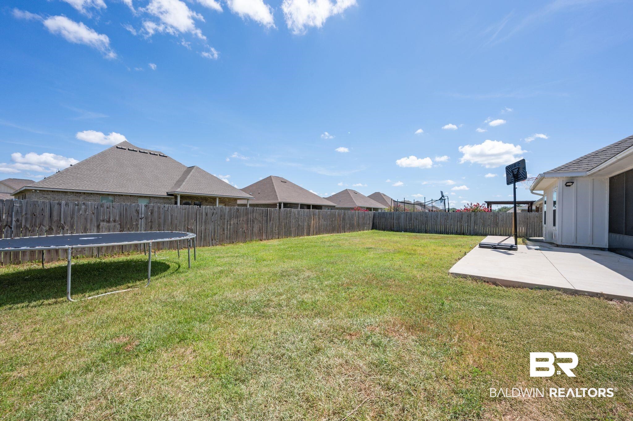 10169 Dunleith Loop Daphne, AL 36526 - Photo 16 of 40 Fenced backyard featuring a patio and a trampoline