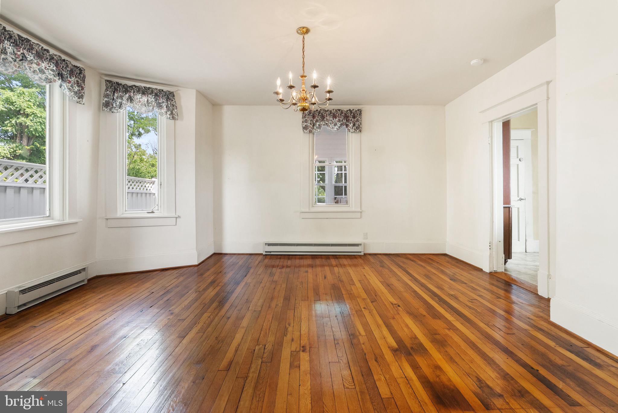 64 Salem Church Road Boyce, VA 22620 - Photo 15 of 59 an empty room with wooden floor chandelier and windows