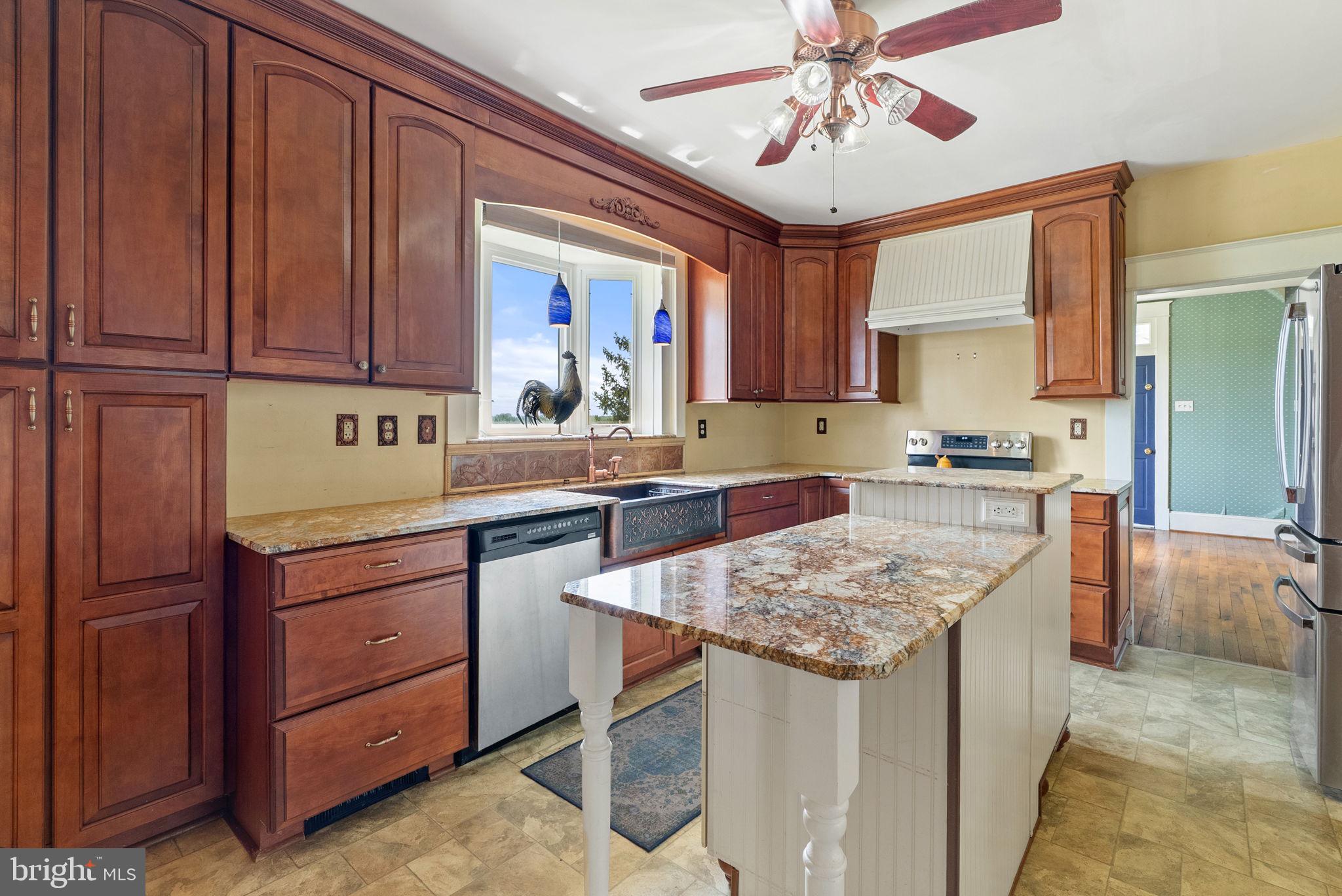 64 Salem Church Road Boyce, VA 22620 - Photo 16 of 59 a kitchen with kitchen island granite countertop wooden cabinets a sink and dishwasher
