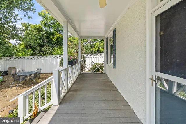 a view of balcony with wooden floor and fence