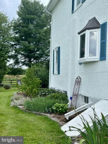 a view of a patio with table and chairs with wooden fence and plants