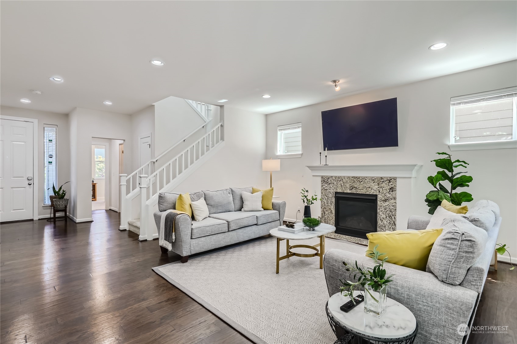 3606 196th Place Southeast Bothell, WA 98012 - Photo 6 of 39 a living room with furniture a fireplace and a flat screen tv
