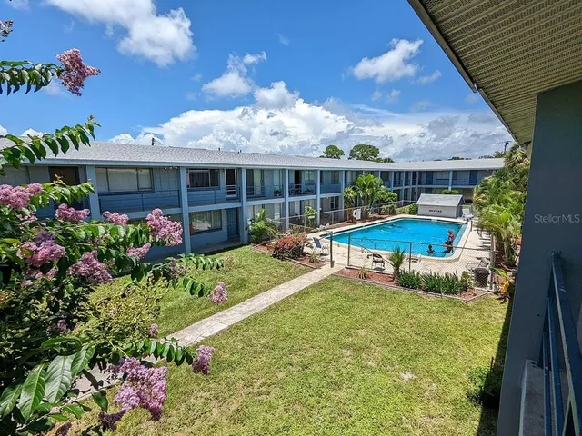 a view of a house with backyard sitting area and garden