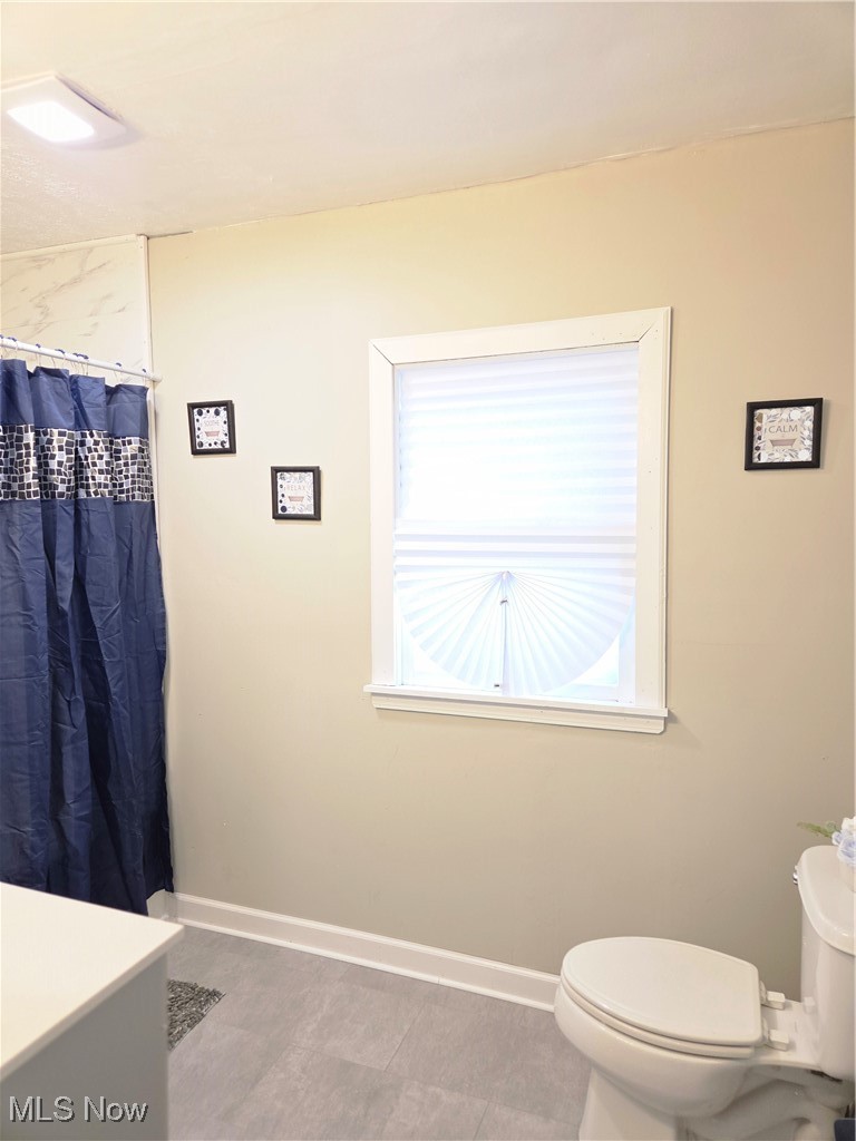 3797 Delmore Road Cleveland, OH 44121 - Photo 20 of 39 Full bathroom featuring a shower with shower curtain and light tile patterned flooring