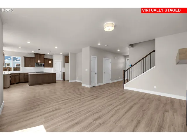 a view of a livingroom with wooden floor and a fireplace