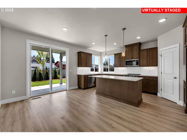 a kitchen with stainless steel appliances a sink stove and microwave