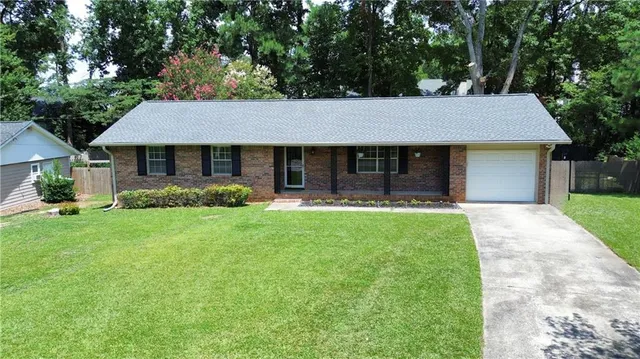 a front view of house with yard and green space