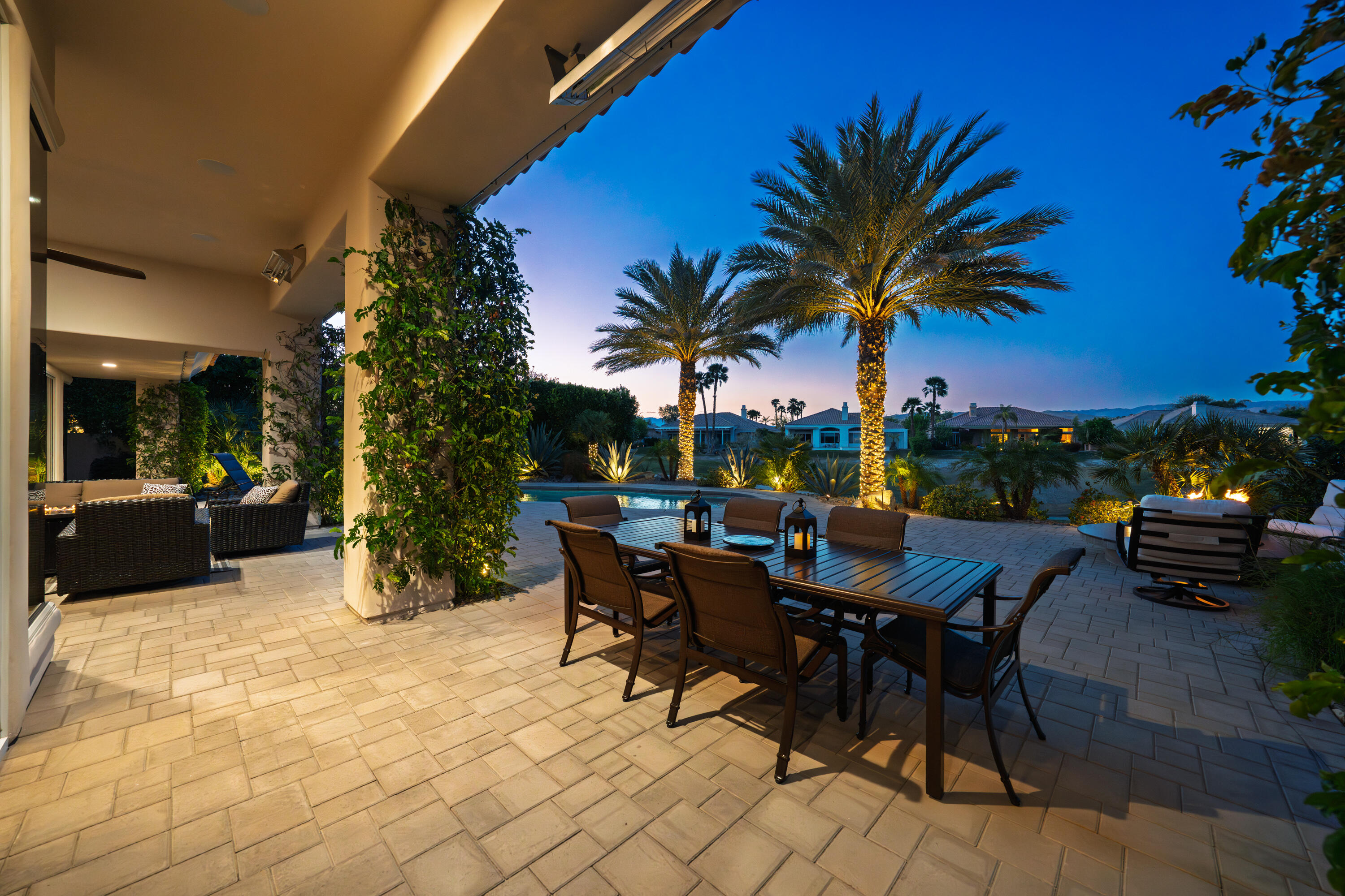269 Loch Lomond Road Rancho Mirage, CA 92270 - Photo 6 of 53 a view of a patio with dining table and chairs under an umbrella