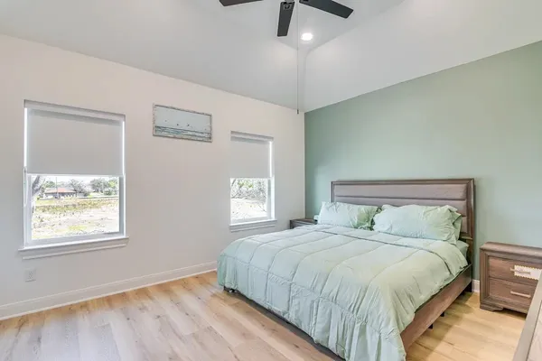 a bedroom with a large bed and a window