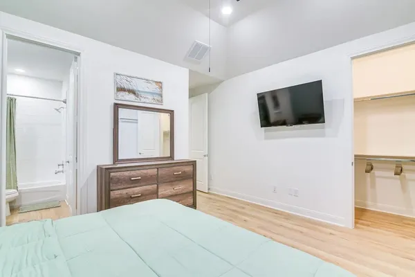 a bedroom with a bed and a flat screen tv