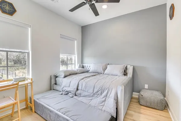 a bedroom with a bed and wooden floor