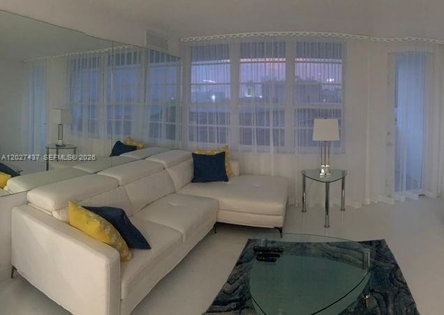 100 Lincoln Road, Unit 1535 Miami Beach, FL 33139 - Photo 1 of 6 a living room with furniture and a lamp