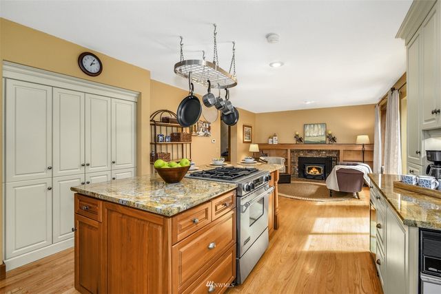 a kitchen with a table chairs stove and cabinets