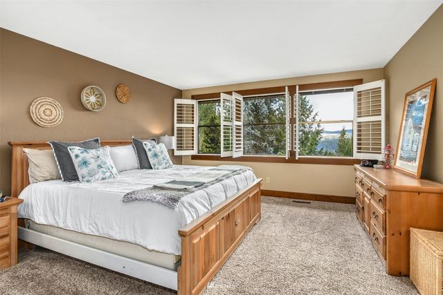 a bathroom with a granite countertop sink a mirror and a shower