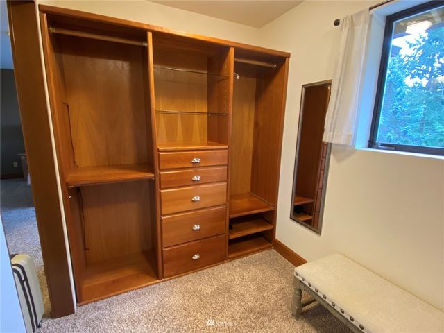 a view of a workspace with a table and a potted plant