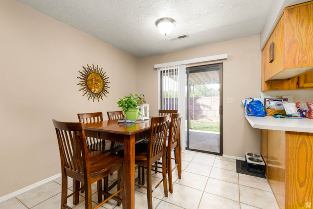 3707 Gates Circle Santa Clara, UT 84765 - Photo 7 of 19 Dining space featuring a textured ceiling and light tile patterned floors