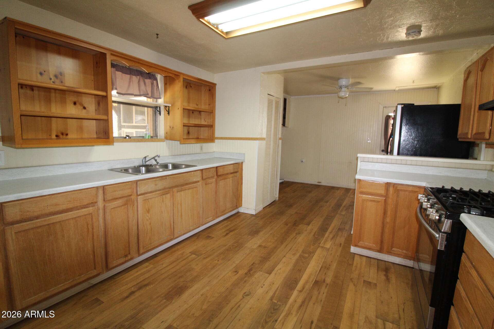 5733 Globe Canyon Road Globe, AZ 85501 - Photo 15 of 30 a kitchen with stainless steel appliances granite countertop a sink and wooden cabinets