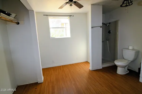 a bathroom with a toilet and a mirror