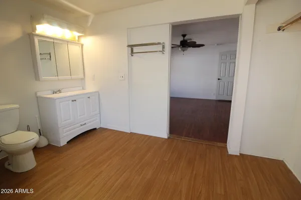 an empty room with wooden floor and window