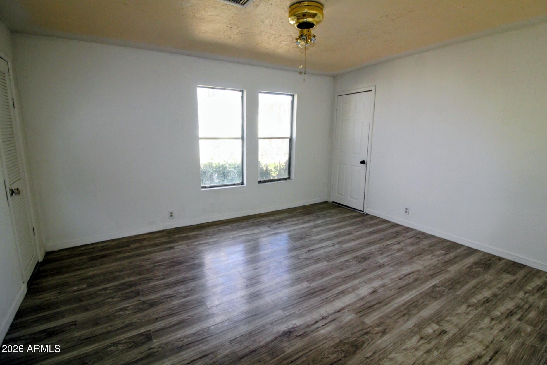 5733 Globe Canyon Road Globe, AZ 85501 - Photo 25 of 30 an empty room with wooden floor and window
