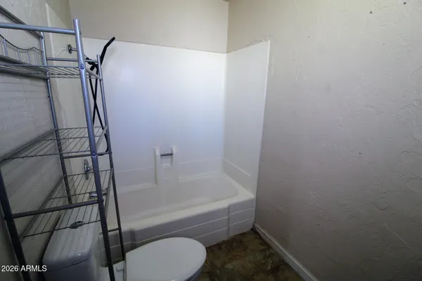 a bathroom with a toilet sink shower and mirror