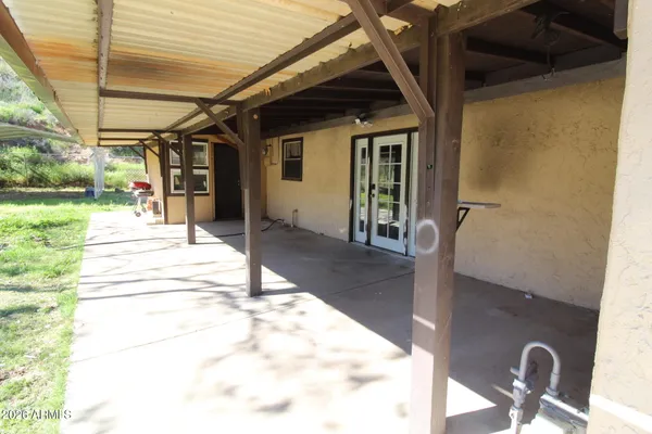 a view of a porch with a table and chairs