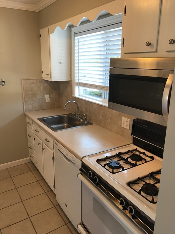 1 Markham Circle, Unit D Ayer, MA 01432 - Photo 4 of 13 a kitchen with a stove and a microwave
