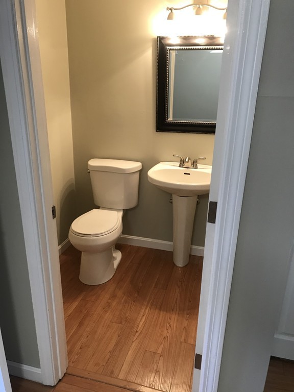 1 Markham Circle, Unit D Ayer, MA 01432 - Photo 5 of 13 a bathroom with a toilet sink and mirror