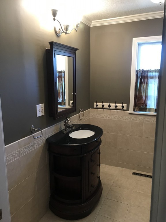 1 Markham Circle, Unit D Ayer, MA 01432 - Photo 9 of 13 a bathroom with a sink and mirror