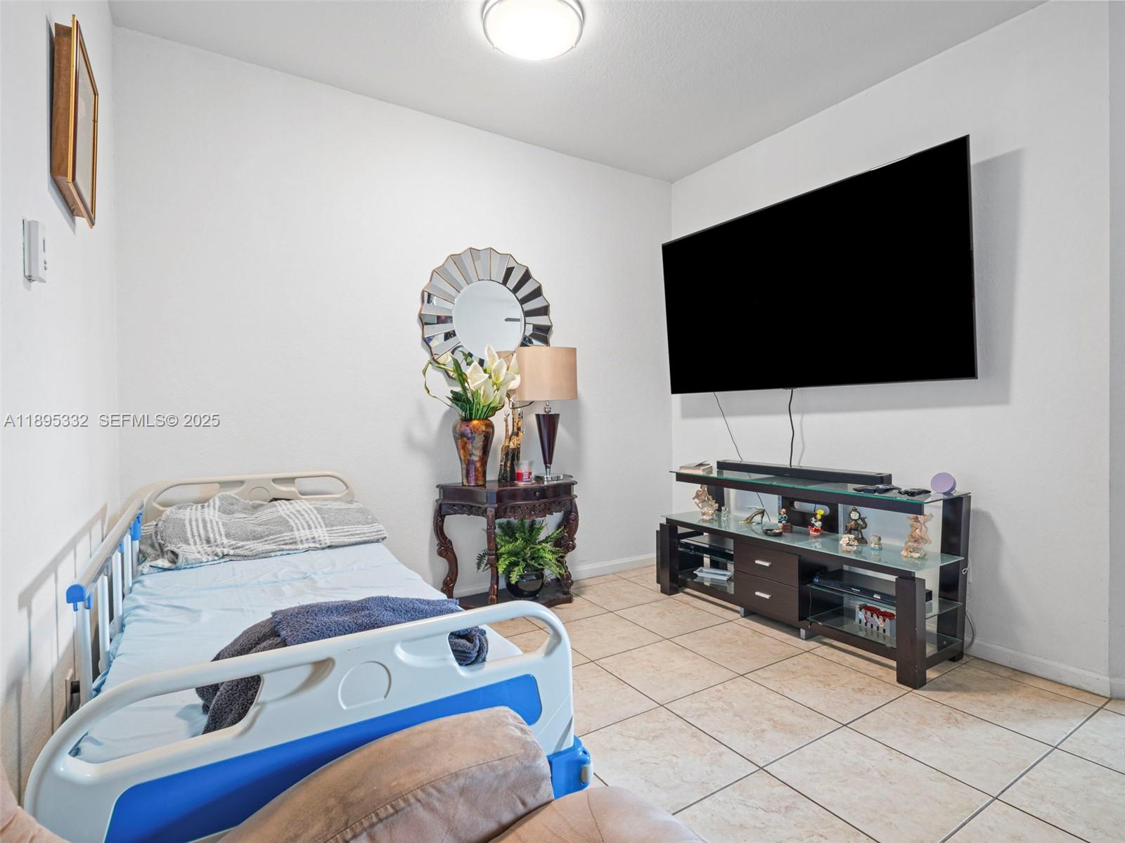 2104 Northeast 3rd Court Homestead, FL 33033 - Photo 11 of 35 a bedroom with furniture and a flat screen tv