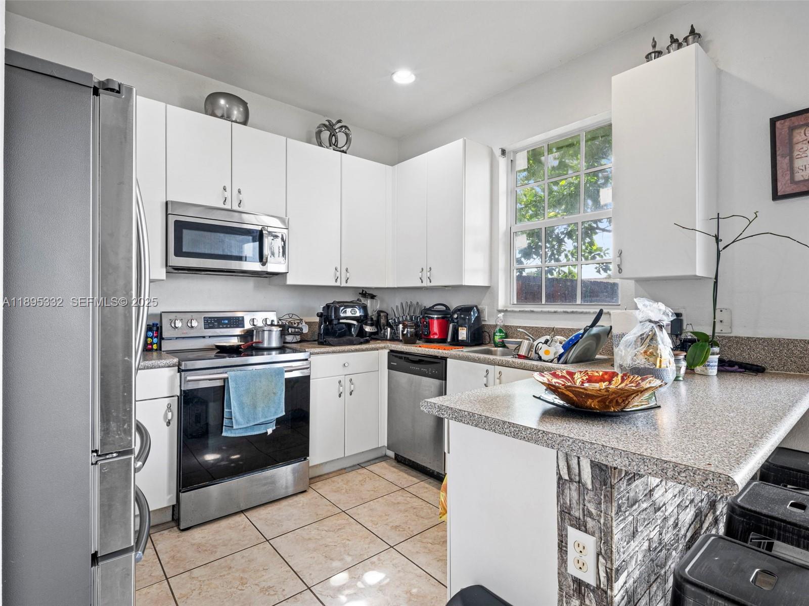 2104 Northeast 3rd Court Homestead, FL 33033 - Photo 12 of 35 a kitchen with a sink appliances and cabinets