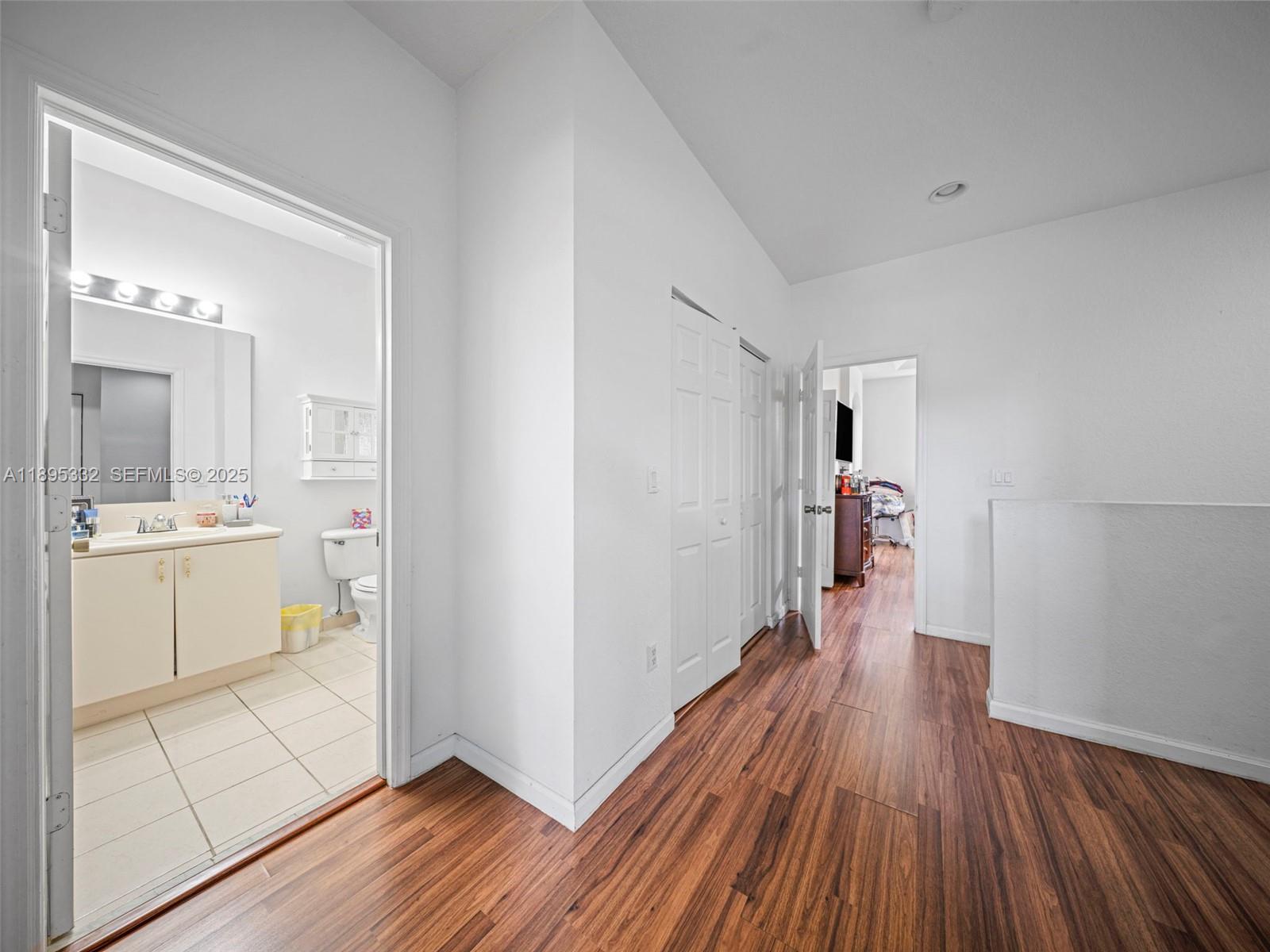2104 Northeast 3rd Court Homestead, FL 33033 - Photo 17 of 35 a hallway with cabinets and wooden floor