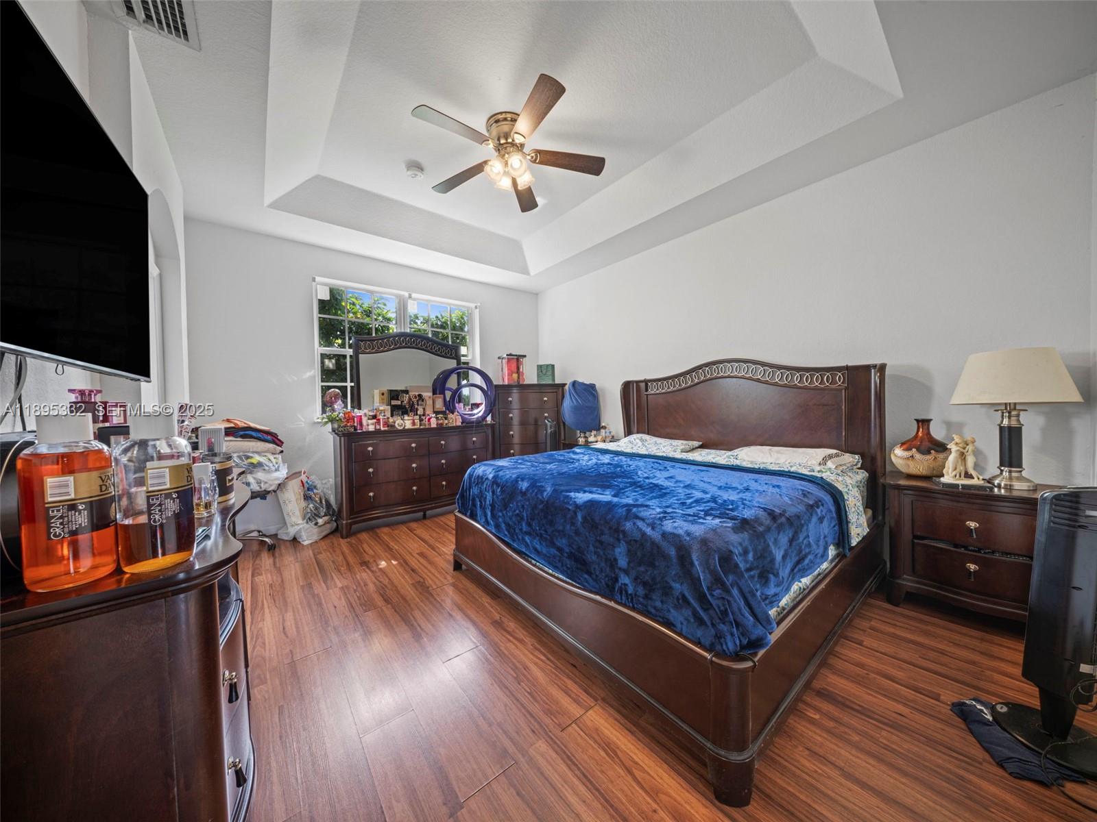 2104 Northeast 3rd Court Homestead, FL 33033 - Photo 20 of 35 a bedroom with a bed and flat tv screen on the dresser