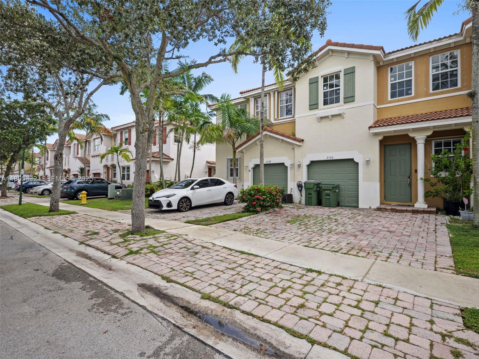 2104 Northeast 3rd Court Homestead, FL 33033 - Photo 2 of 35 a view of a white house with a yard and pathway