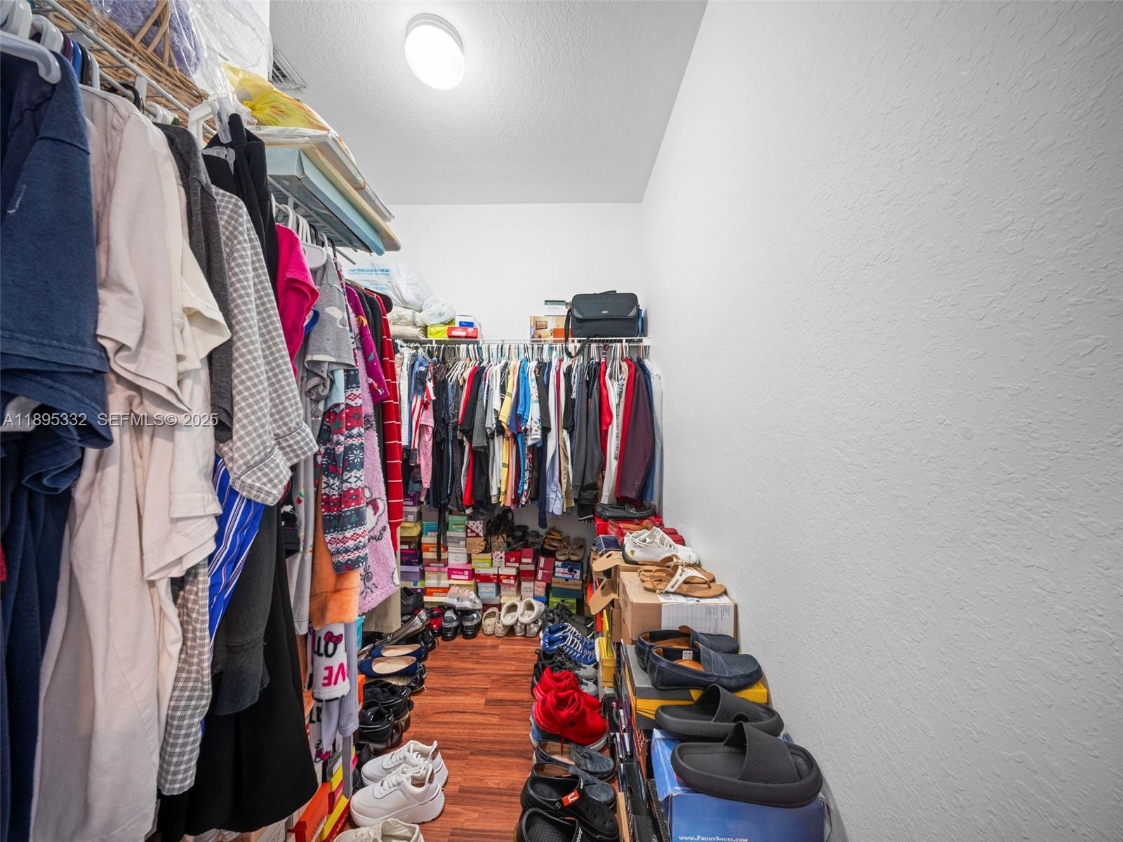 2104 Northeast 3rd Court Homestead, FL 33033 - Photo 21 of 35 a view of walk in closet with clothes